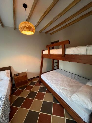a room with two bunk beds and a lamp at Colonial Beach Airport Hotel in Cartagena de Indias