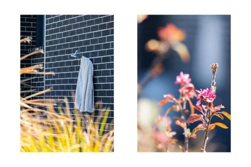 a towel hanging on a brick wall next to a plant at Tipsy Turtle Beach House in Burrill Lake