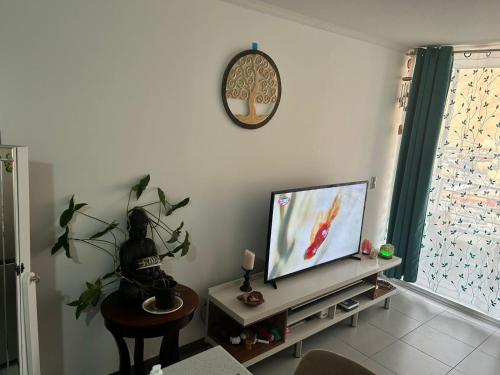 a living room with a flat screen tv on a table at Arriendo diario departamento completamente amoblado in Iquique