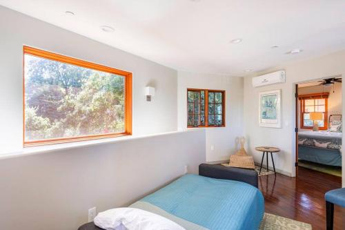 a bedroom with a bed and a window at The Little Pumpkin Guest House in San Diego