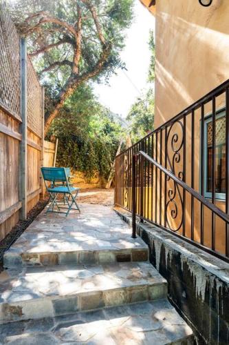 a bench sitting on a walkway next to a building at The Little Pumpkin Guest House in San Diego