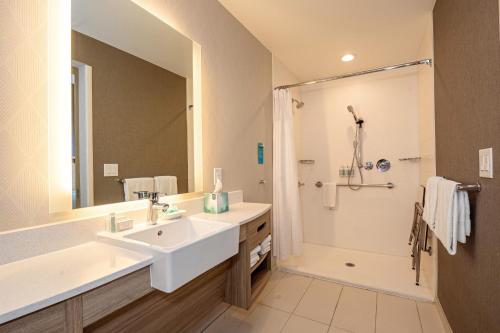 a bathroom with a sink and a shower at SpringHill Suites by Marriott Dallas McKinney in McKinney