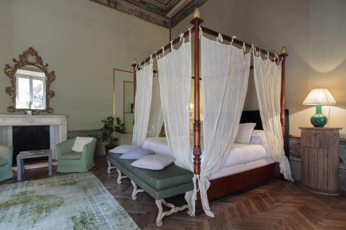a bedroom with a four poster bed with a canopy at Al Palazzo del Marchese di Camugliano Residenza d'Epoca in Florence