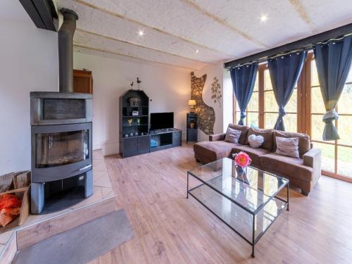 a living room with a couch and a fireplace at Charming holiday home in Durbuy with garden in Durbuy