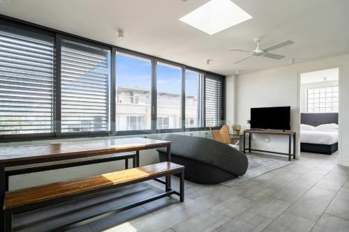 a living room with a couch and a bed at EIGHT TWO NINE TWO IV: BONDI BEACH in Sydney