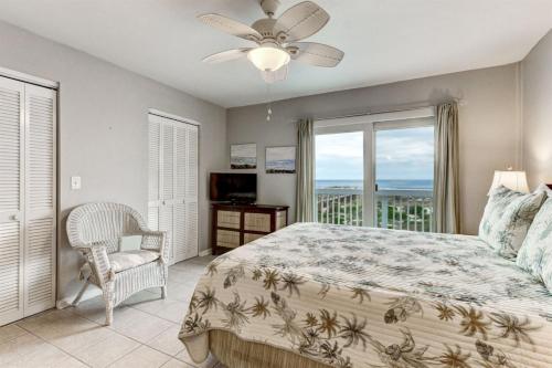 a bedroom with a bed and a view of the ocean at 95066 Sandpiper Loop in Fernandina Beach