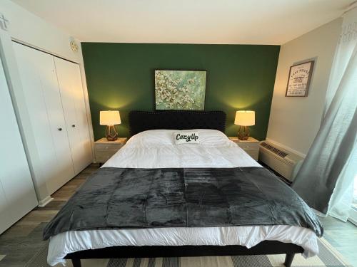 a bedroom with a large bed and two lamps at Newly Updated Modern, Spacious, and Cozy Condo- Right on the Lake! in Lake Geneva