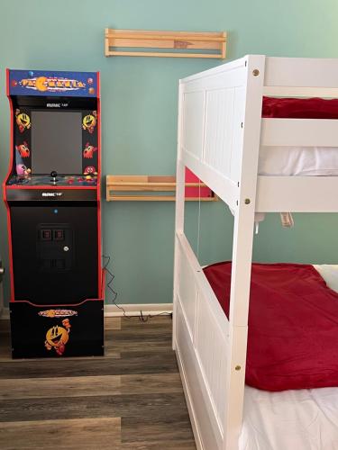 a bedroom with a bunk bed and a video game at Newly Updated Modern, Spacious, and Cozy Condo- Right on the Lake! in Lake Geneva