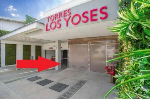 a building with a red arrow in front of it at 1001 Torres Los Yoses Apartamento con A/C y parqueo full equipado in San José