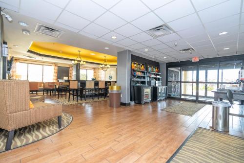 a dining room and lobby of a restaurant with wooden floors at Hampton Inn by Hilton Spring Hill in Timber Pines