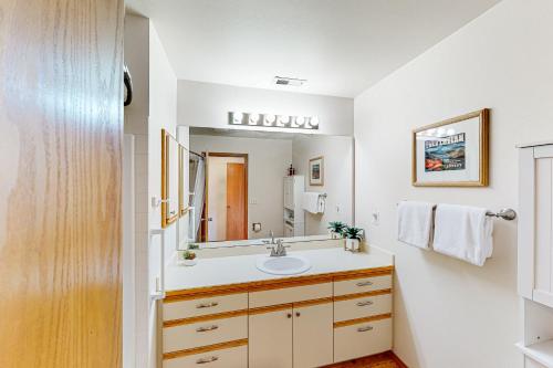 a bathroom with a sink and a mirror at Lake Chelan Shores: The Overlook #19-9 in Chelan