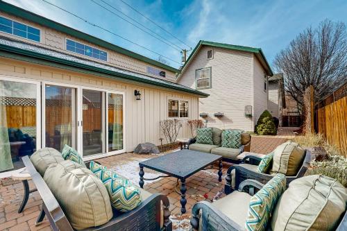 a patio with couches and a table in front of a house at Flagstaff Fantasy - Casita in Flagstaff
