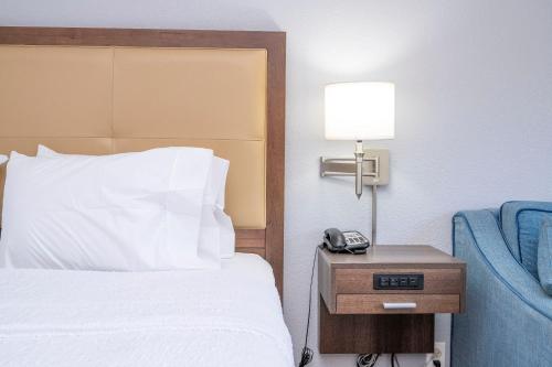 a hotel room with a bed and a phone on a night stand at Hampton Inn by Hilton Spring Hill in Timber Pines