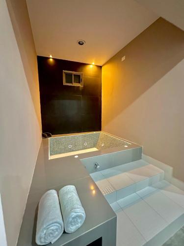 a bathroom with a sink and a mirror and towels at Hotel Zibahun in Valladolid