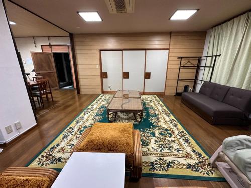 a living room with a couch and a rug at Marina bay Numazu マリーナベイ沼津 BBQ可 in Numazu