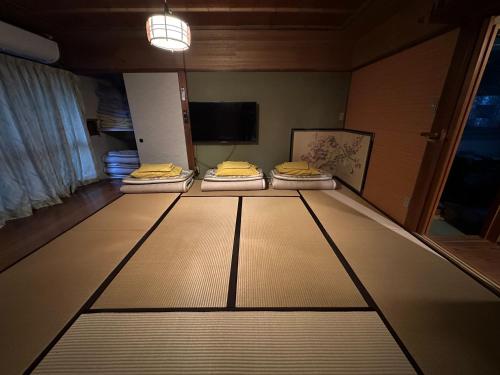 a room with three mattresses on top of a floor at Marina bay Numazu マリーナベイ沼津 BBQ可 in Numazu
