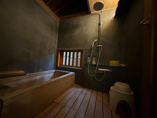 a bathroom with a tub and a shower and a toilet at Marina bay Numazu マリーナベイ沼津 BBQ可 in Numazu