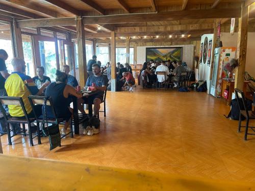 a group of people sitting at tables in a room at May Homestay in Lao Cai