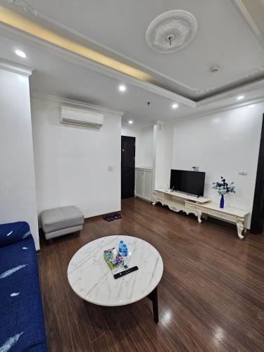 a living room with a couch and a table at The Peninsula Haiphong in Hai Phong