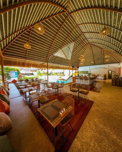 a large room with tables and chairs and a pool at Bathala Resort in Panglao