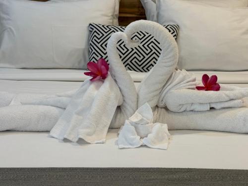 a bed with towels in the shape of a heart at Villa Majegau 1 by Deasha in Seminyak