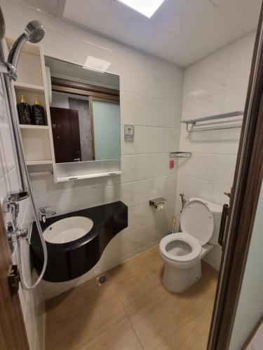 a bathroom with a toilet and a sink at Mashley Room Prestige Apartment SKY HOUSE BSD in Cilandak