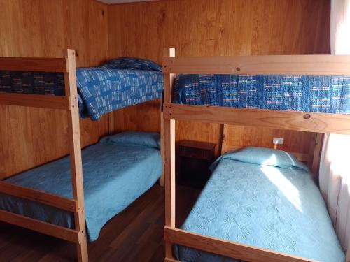 a couple of bunk beds in a room at Cabañas Marlen in Limache