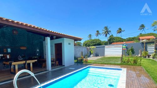 uma villa com uma piscina e uma casa em Viva Guaibim: Casa de Praia com Piscina e Churrasqueira em Guaibim