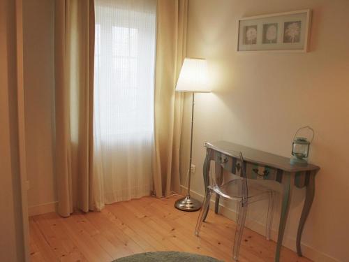 a room with a desk and a lamp and a window at Maison de charme avec équipements bébé, vélos, fibre, proximité rivière - Coulonges - FR-1-653-127 in Coulonges