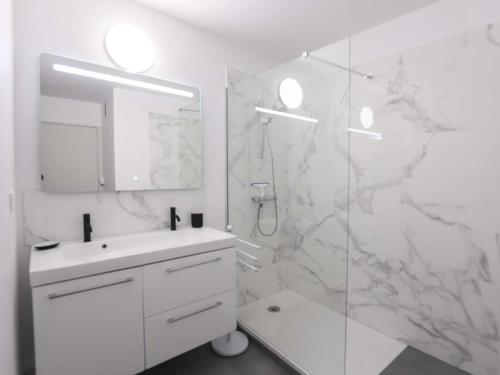 a white bathroom with a sink and a shower at Bel appartement rénové, calme, proche centre et plage, balcon, 2 chambres, commerces à 150m - FR-1-4-685 in Saint-Jean-de-Luz