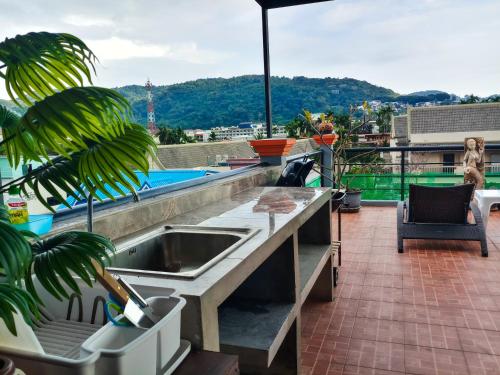 a kitchen with a sink on top of a roof at Kata Lina guesthouse in Kata Beach