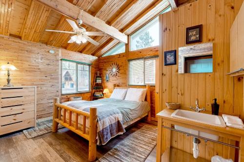 a bedroom with a bed and a sink and a tub at Caribou Cabin in Munds Park