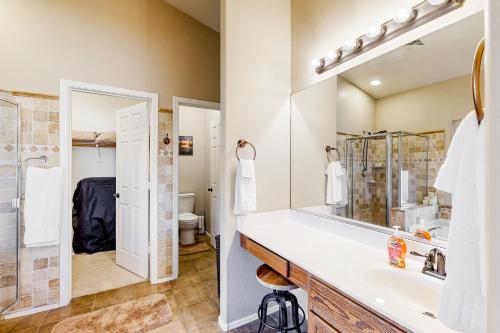 a bathroom with a sink and a mirror at Poolside Tranquility in Queen Creek