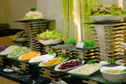 a buffet of different types of food on display at The Art Nest Hotel Nha Trang in Nha Trang