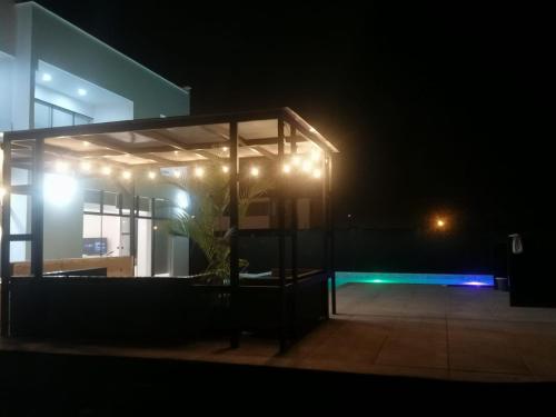 a building lit up at night with lights at Alquilo Casa playa in San Antonio