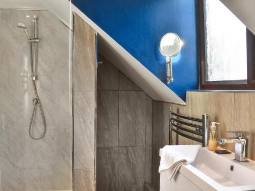 a bathroom with a shower and a sink and a shower at Larpool Mews in Whitby