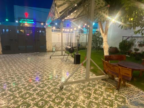 a gazebo with a table and a bench at Villa sân vườn Misa in Phan Thiet