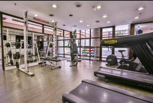 a gym with treadmills and machines in a room at Studio Living Quality Jardins in Sao Paulo