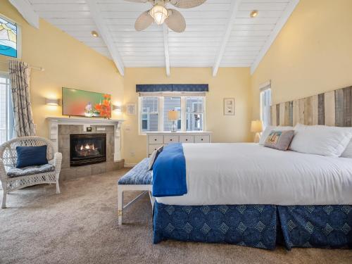 a bedroom with a large bed and a fireplace at Stunning beach home - steps2sand, AC, Large Patio and Fast Wifi! in San Diego