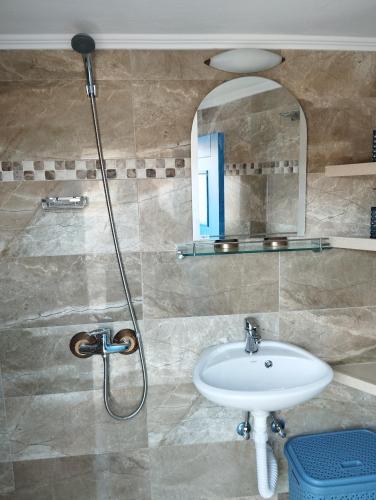 a bathroom with a sink and a mirror at ARCHONTIKO Traditional House 1850 in Olympos