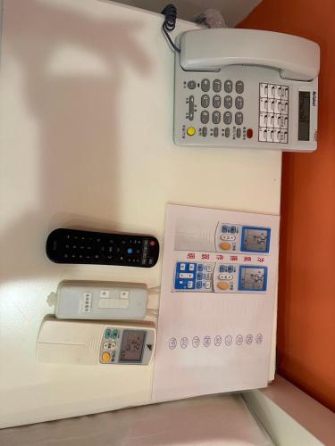 a toy kitchen with a phone on a wall at Bei Ao Bi Shan Jyu in Dongyin