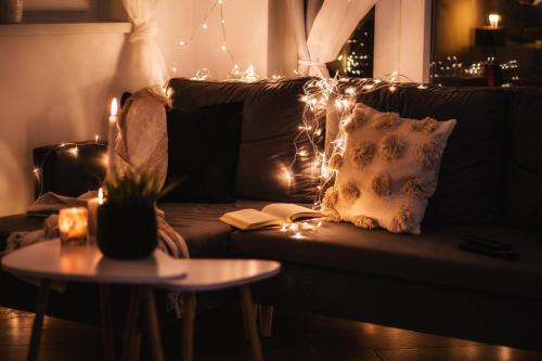 a living room with a couch with christmas lights at Szanna Apartman in Doboz