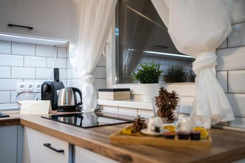 a kitchen with a counter top with a window at Szanna Apartman in Doboz
