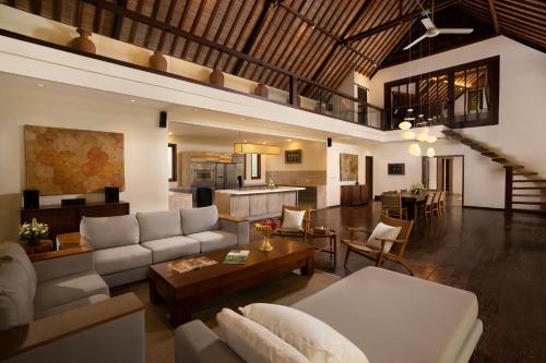 a living room with a couch and a table at Villa Tirtadari by Nakula in Canggu