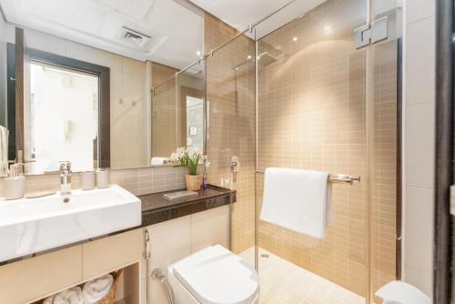 a bathroom with a sink and a toilet and a shower at LUX Holiday Home Dubai Marina JBR - Silverene Tower Studios in Dubai