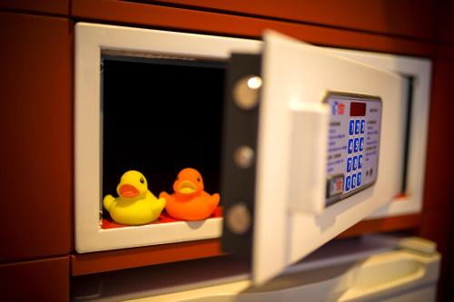 two rubber ducks sitting inside of a microwave at Resotel in Villares de la Reina