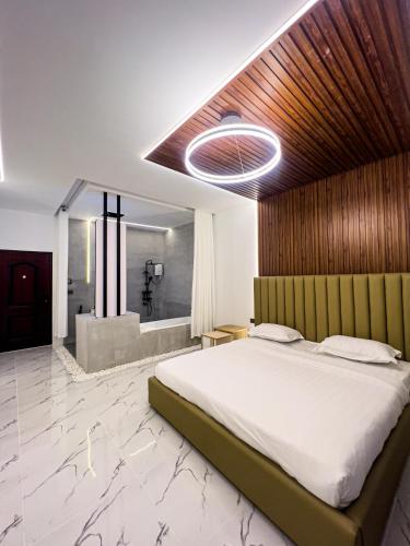 a bedroom with a large bed and a bath tub at K-Road in Phnom Penh