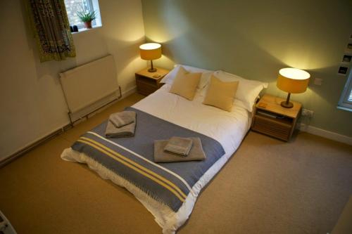 a bedroom with a large bed with towels on it at Inviting & Secluded 1BD House w Patio - Peckham! in London