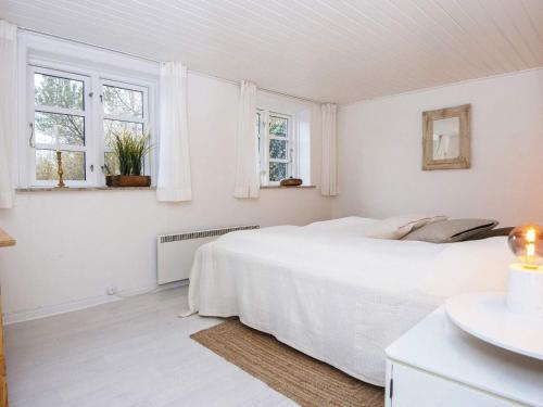 - une chambre blanche avec un lit et 2 fenêtres dans l'établissement Holiday home Rømø CXXI, à Kongsmark