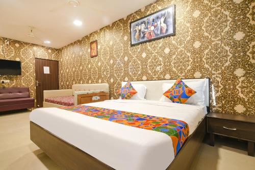 a bedroom with a large bed in a room at FabHotel Prithviraj in Indore